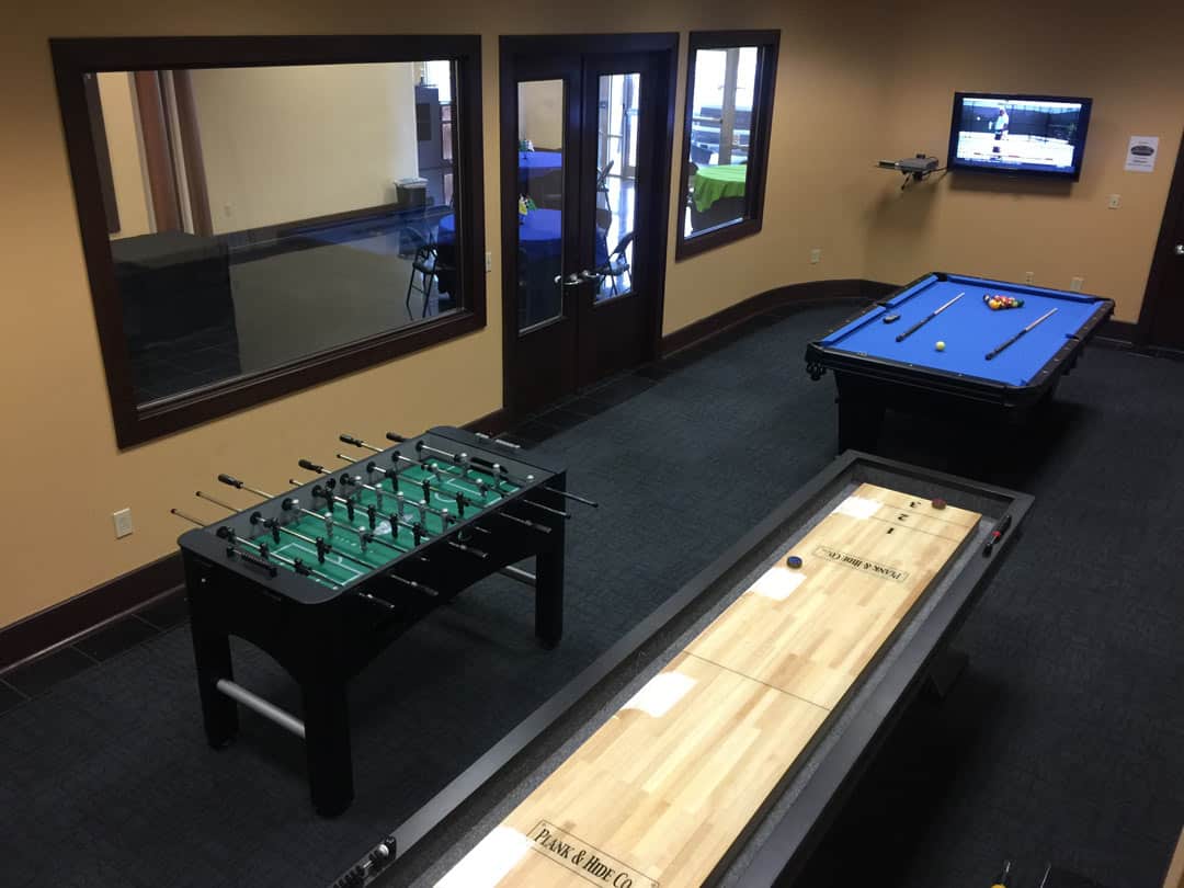 Bluegrass Karting game room with pool table, foosball table, and shuffleboard table
